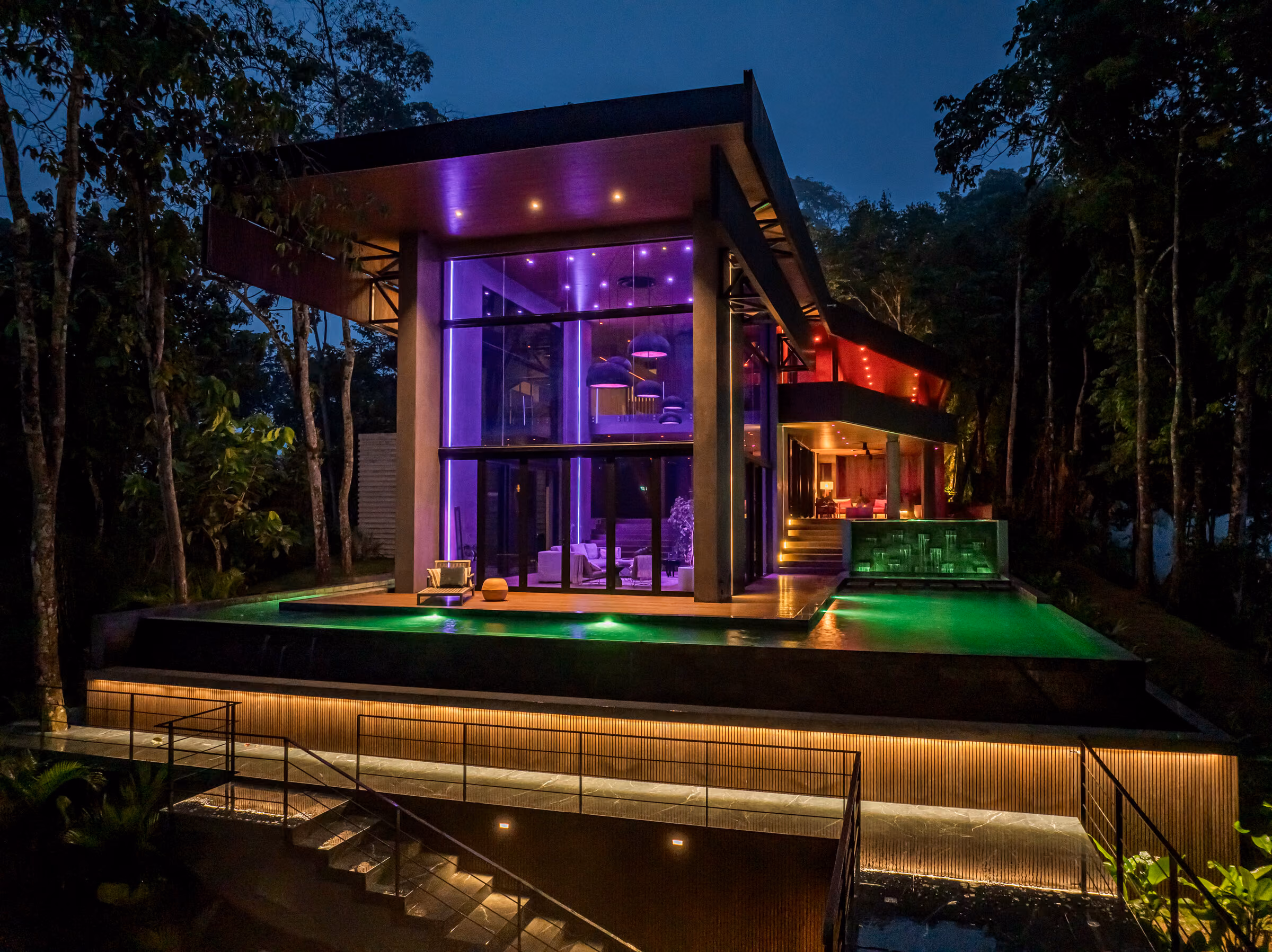 The residence at night with the lighting set to a violet scene.