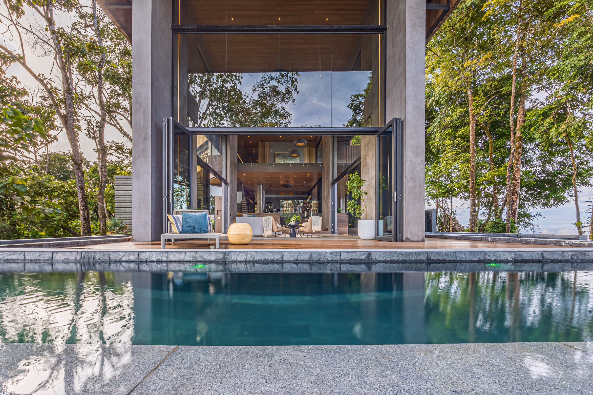 The completed residence seen at a distance across the sloping ground of the estate.
