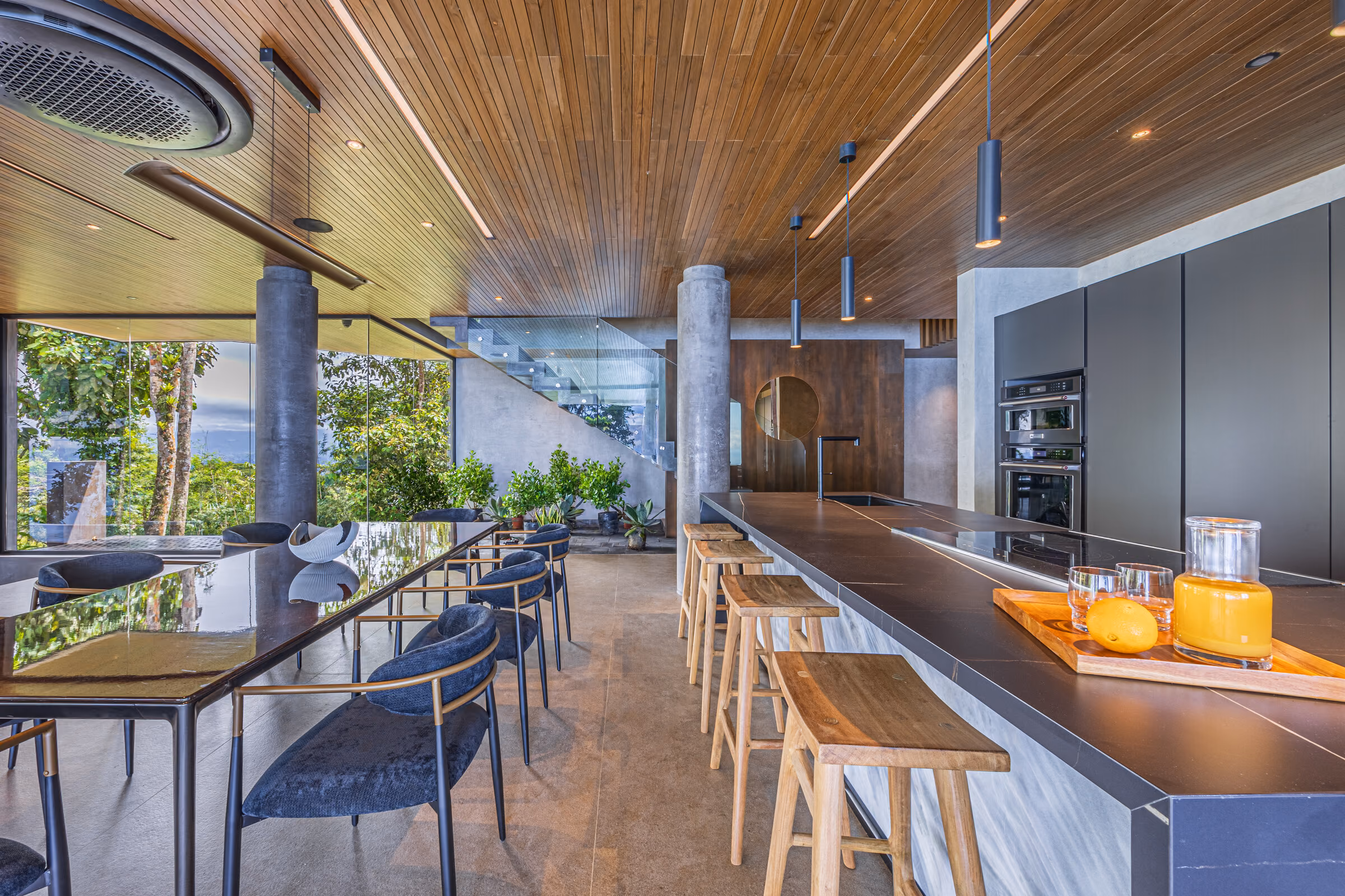 Kitchen detail: dark cabinetry, metal fittings and the warm timber ceiling above.